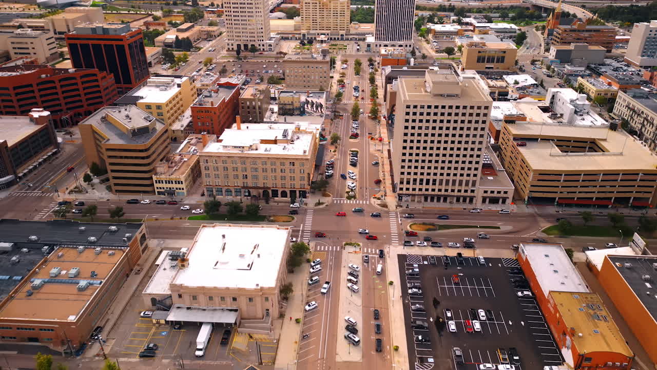 Streets of modern American city with lively traffic. Drone footage over the roads and parking lots of Colorado Springs, Colorado, USA