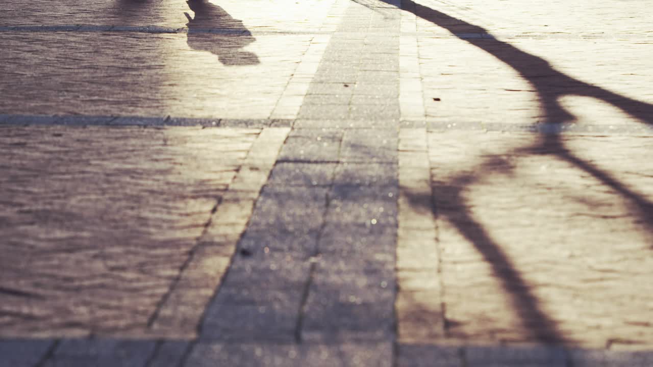 Feet entering, transparent globe fading and rotating while walkers passing, showing global reach
