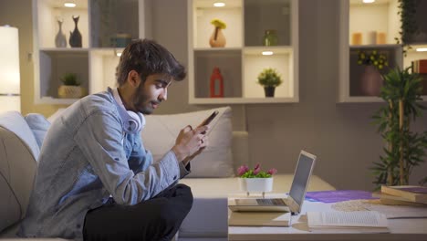 Man-texting-on-the-phone-with-happy-expression.