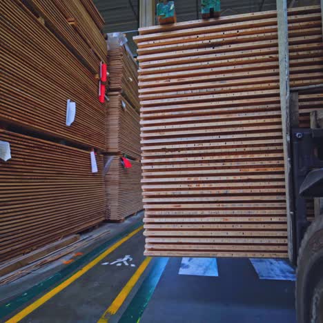 interior of a plant for wooden production. factory for parquet board. view from truck carrying plywood indoors.