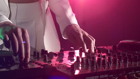 female dj performing on a dj mixer