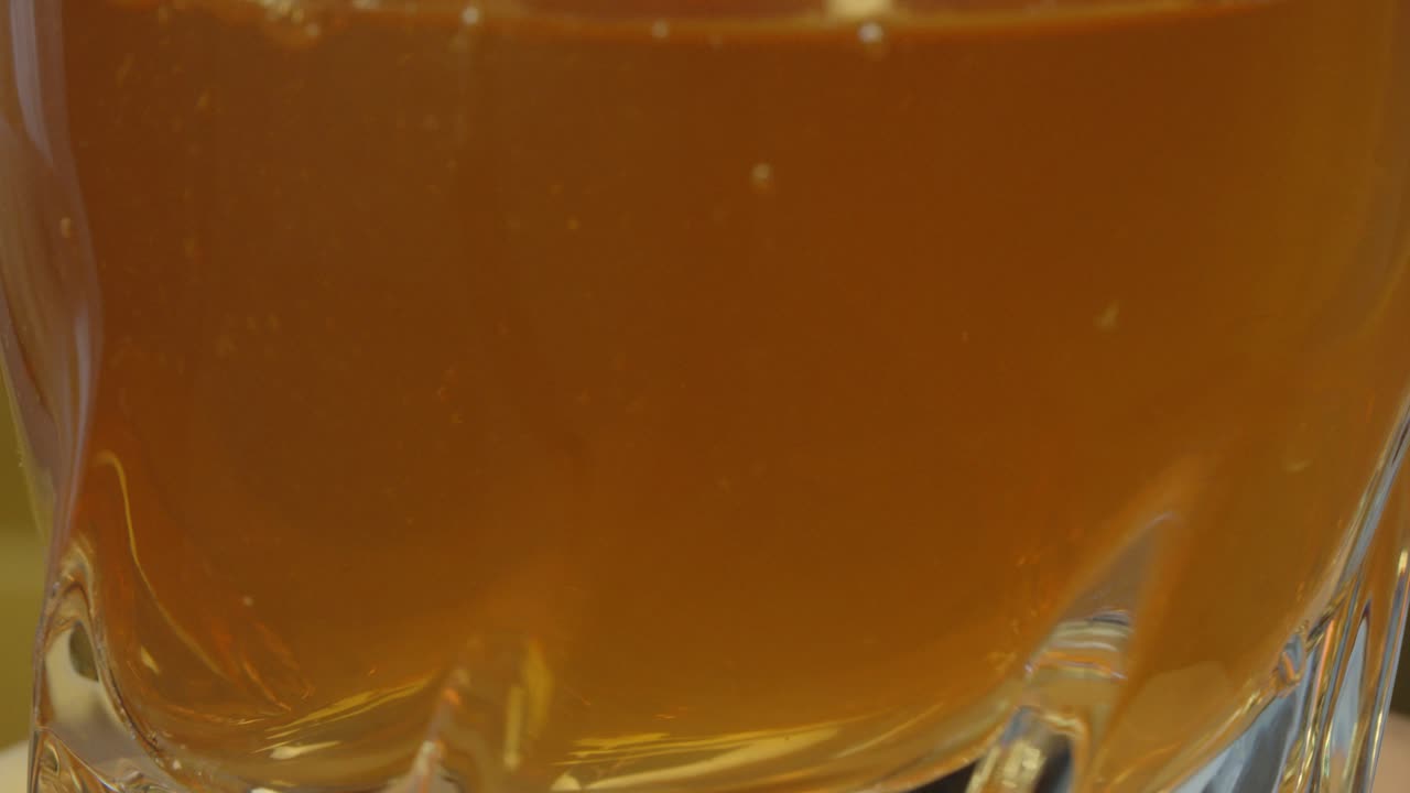 ice tea is poured into a glass