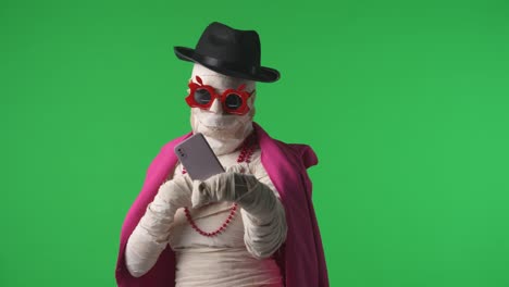 green screen isolated chroma key video capturing a mummy dancing and singing actively into the - green screen isolated chroma key video capturing a mummy dancing and singing actively into the microphone. haloween holidays. mock up, workspace for your promotion clip or advertisement