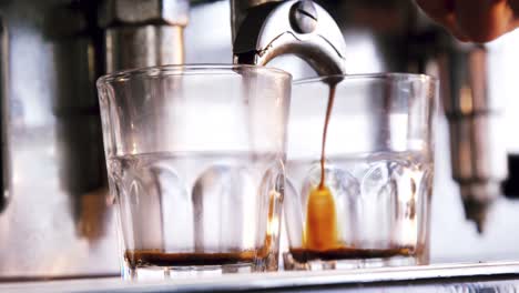 Close-up-of-espresso-pouring-from-coffee-machine