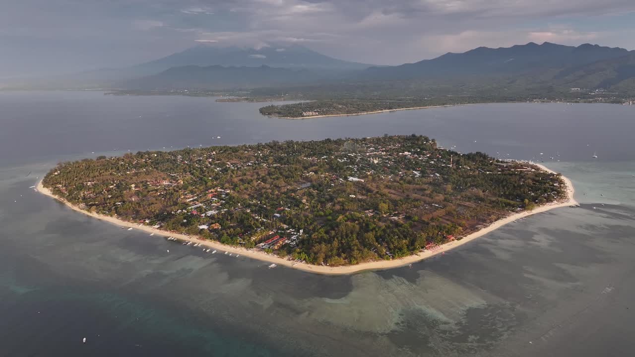 Birds eye view of small island of Gili Air and Mt Rinjani in Lombok on horizon. Indonesia