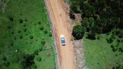 Jeep-Driving-Through-Country-Road-Over-The-Mountains-In-Uganda,-East-Africa