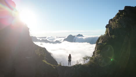 independent girl watches over mountain landscape, standing on mountain ridge, feminism concept