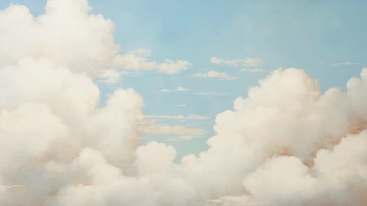 A serene sky with fluffy clouds, captured from a low-angle perspective, ideal for a calming video