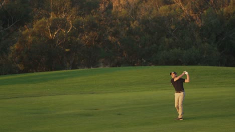 A-golfer-takes-a-swing-on-a-golf-course