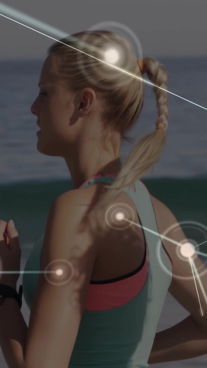 Vertical video: Female runner pacing beach wrist device sending fitness data, linking network nodes