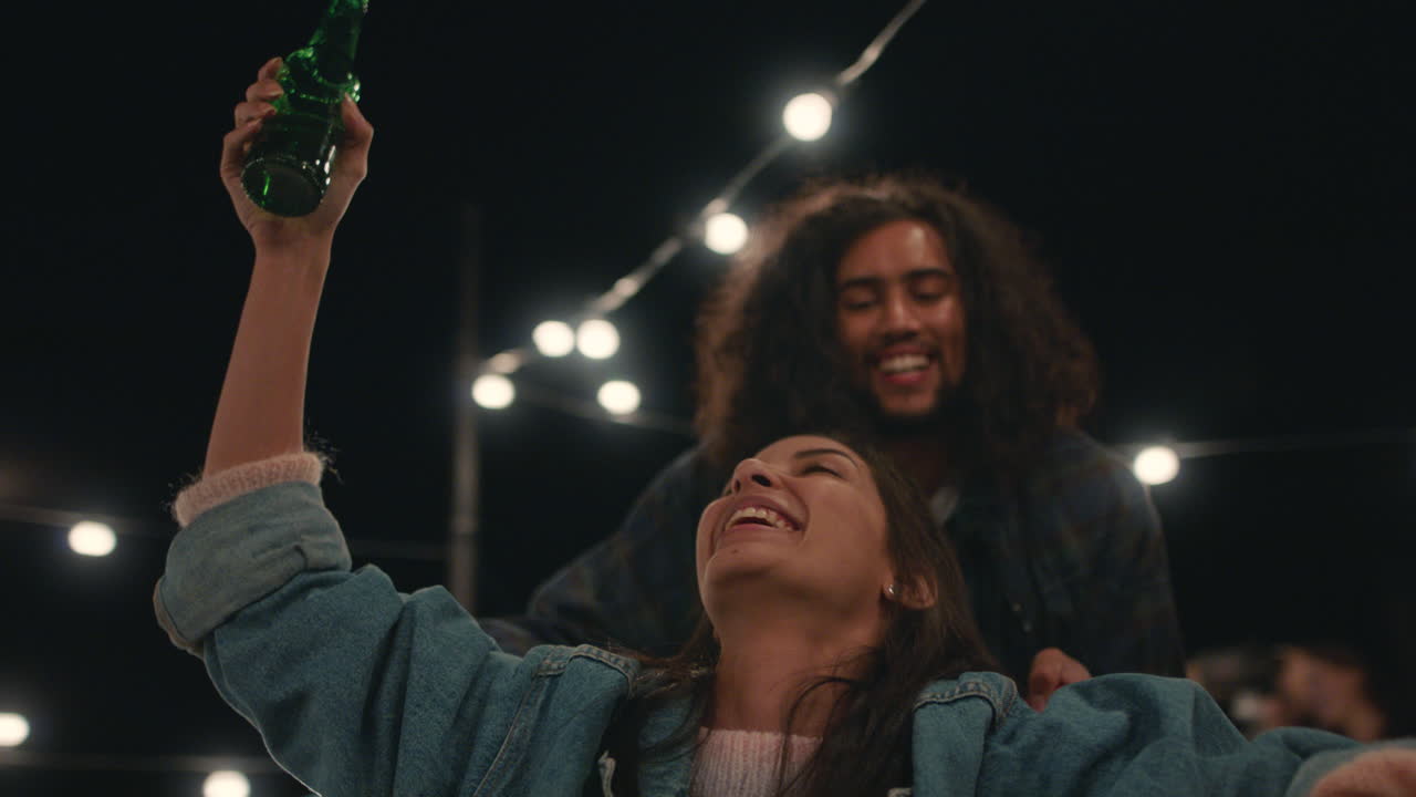 beautiful young woman having fun sitting in shopping cart group of friends enjoying crazy rooftop party at night playfully celebrating weekend