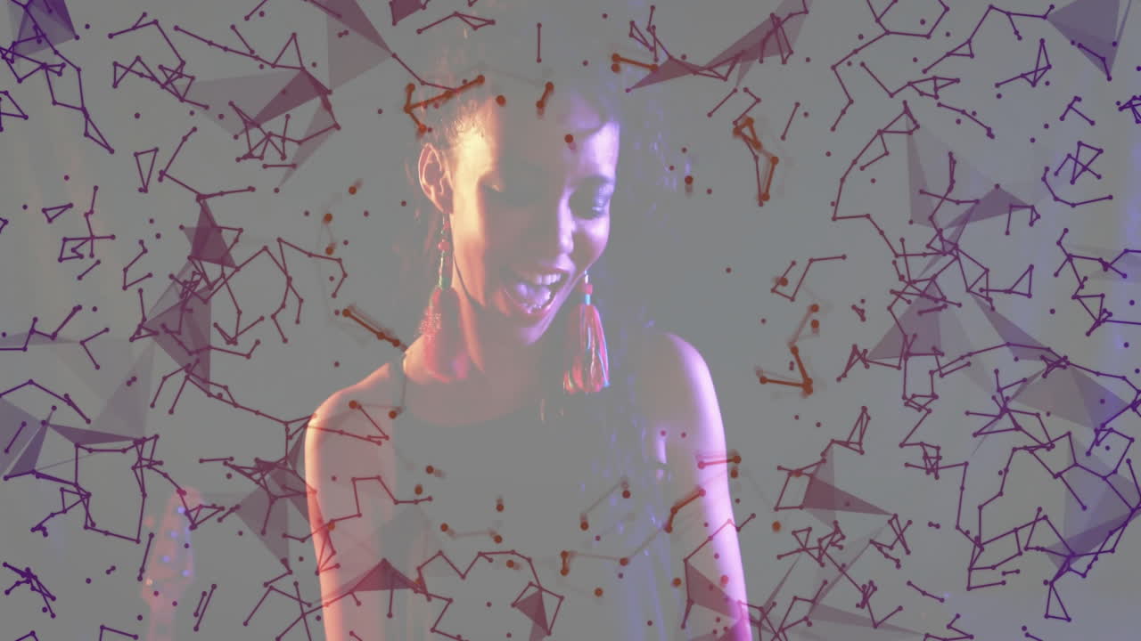 Woman wearing red tassel earrings presenting data network visuals projecting node-and-line graphics