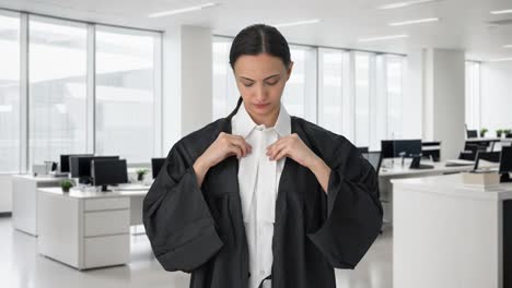 Serious-Indian-female-lawyer-wearing-gown