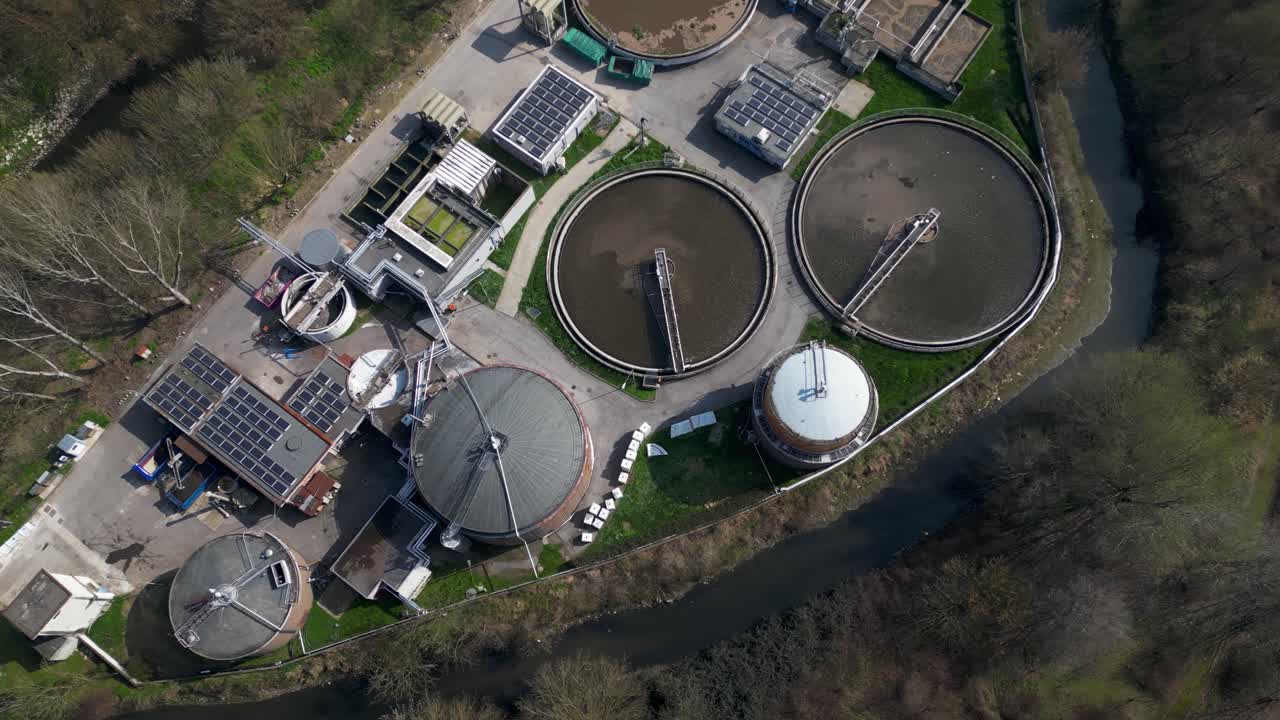 Aerial drone view of advanced water treatment infrastructure in Milan, Italy. Industrial facility integrates smart processing systems, wastewater management and energy recovery technologies