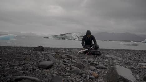 tourist preps drone by icelandic glacial lagoon