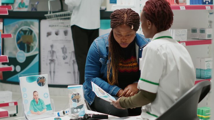 Pharmacist consulting with a customer in a pharmacy
