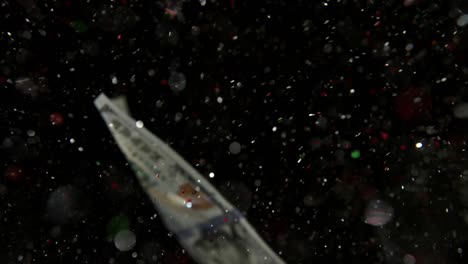 falling flying american dollar banknotes and flying mixing with the glitter sparkles on a black background in 4k loopable. high quality falling dollar banknotes in 4k. video is loopable
