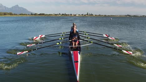 Four-senior-caucasian-men-and-women-rowing-boat-on-a-river