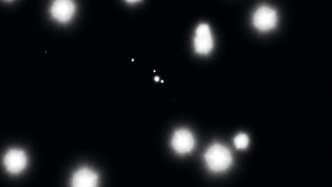 animation of glowing white spots of light moving in hypnotic motion on black background