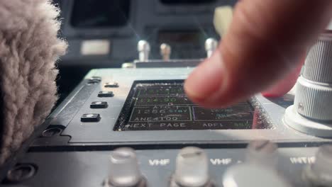 captain selecting radio frequency in the comunication box, close-up shot