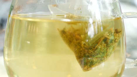 green tea and tea bag on table, close up