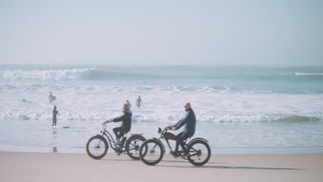 couple riding bikes at the beach