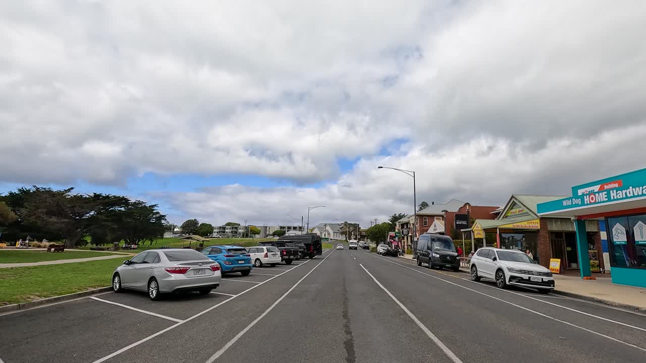 A 55-second drive through a coastal town on Great Ocean Road, showcasing vibrant streets and overcast skies