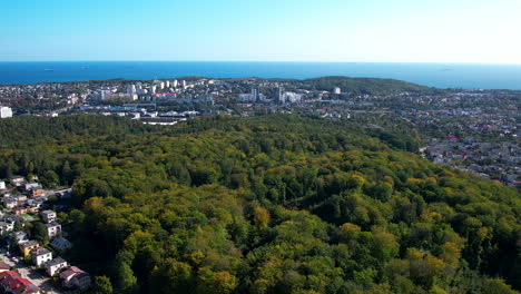 Suburban-town-surrounded-by-the-forest-of-Witomino-Gdynia-Poland,-aerial