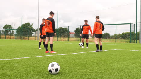 practicing teamwork, soccer players wearing orange jerseys focusing on field skills