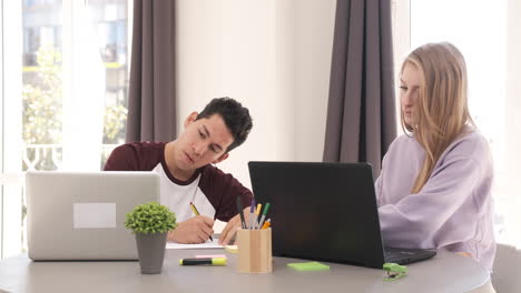 focused young freelancer couple sitting at desk working at home. freelance, home office, remote work, online concept