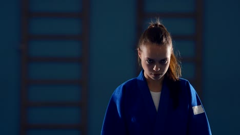 beautiful girl fighter looks at the enemy, a stern look. portrait view. circular motion of the camera.