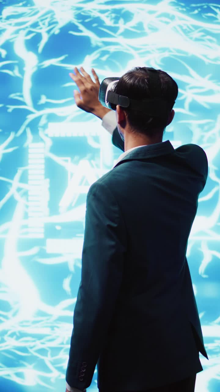 Vertical video Computer scientist wearing VR headset interacting with AI visualization