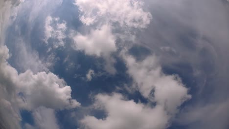 blue sky and layer of clouds moving about in a fine sunny afternoon