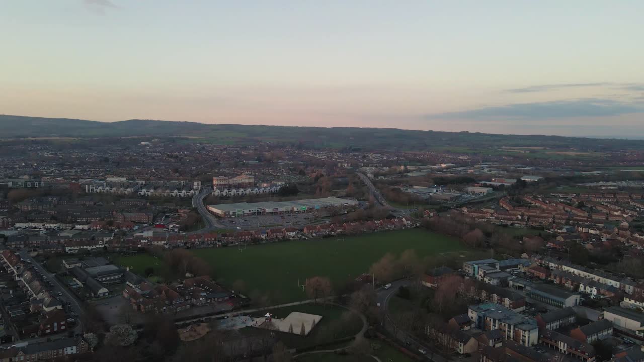 4K aerial panoramic view of  the sunset over taunton Somerset, United Kingdom, drone rotating to the right and showing the blue sky with some clouds. 60fps