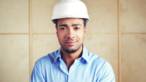 Happy-foreman-with-arms-folded-at-building-site-inspection