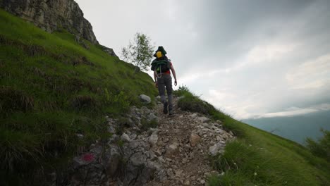 lombardy, italy - a mountain climber navigating the rocky path to the peaks of grignetta - low angle shot