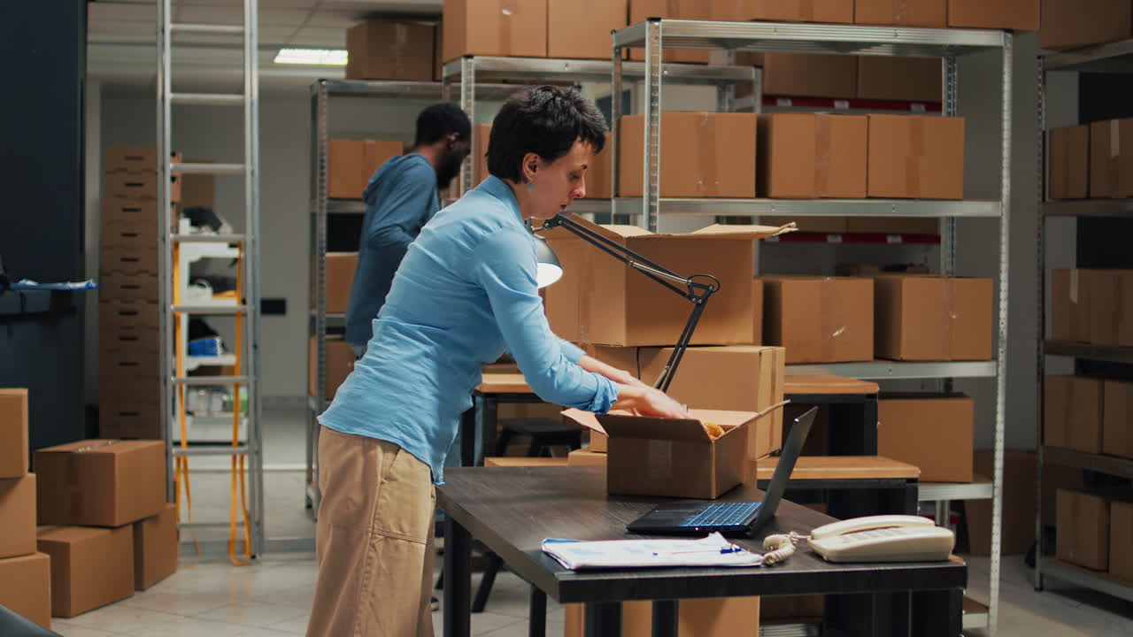 Warehouse workers packing boxes for shipping