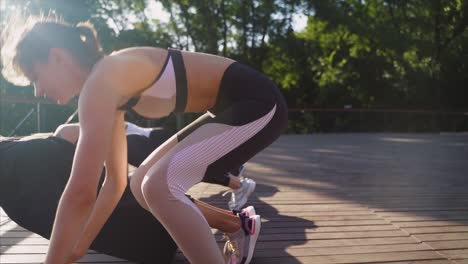 women doing push-ups outdoors