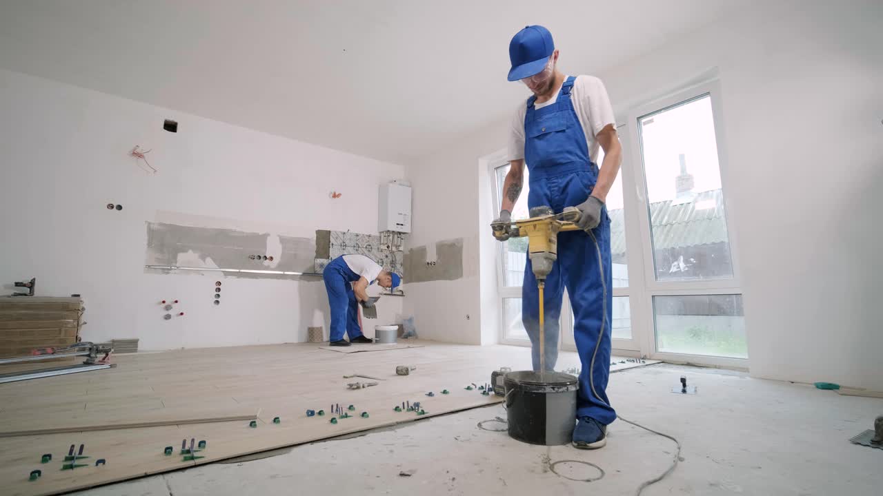 Construction, renovation, repair apartment. Installing ceramic floor tiles - measuring and cutting the pieces. Cuts tile. Tile cutting
