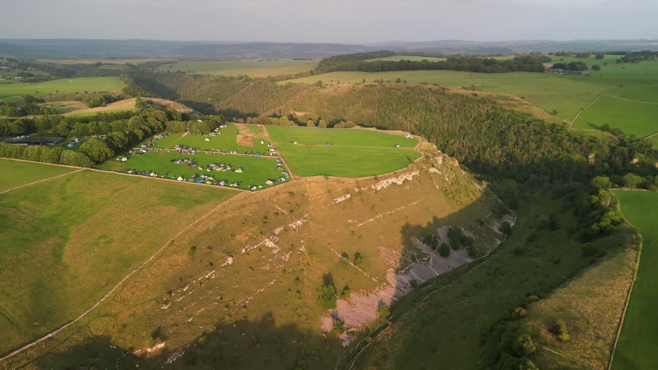 Beautiful Lathkill Dale - Haddon Grove Farm Campsite approach by drone in golden hour, The Peak District, Derbyshire, UK