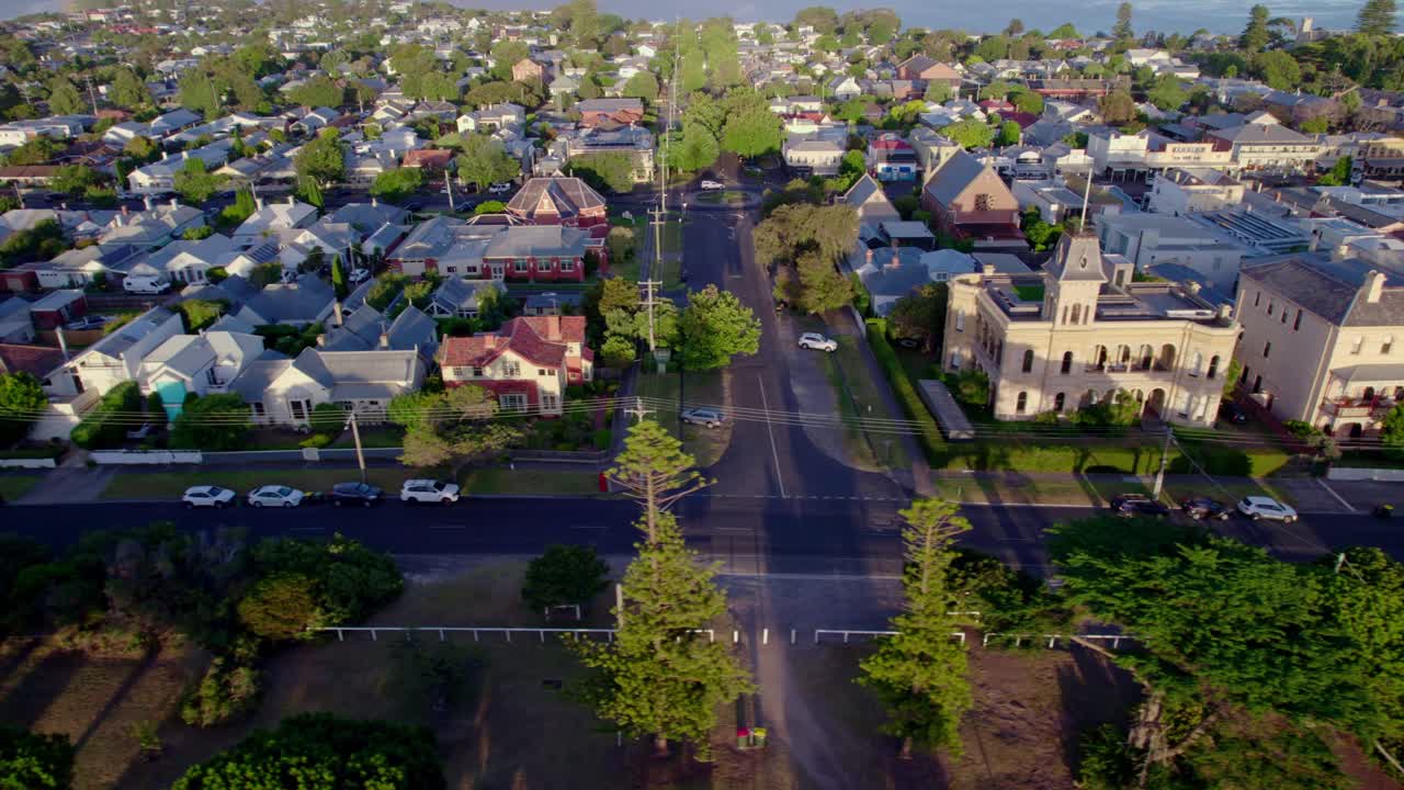 Aerial sideways tracking, Queenscliff town along Gellibrand St, sunrise