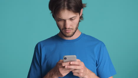 Caucasian-man-in-front-of-camera-on-blue-background.