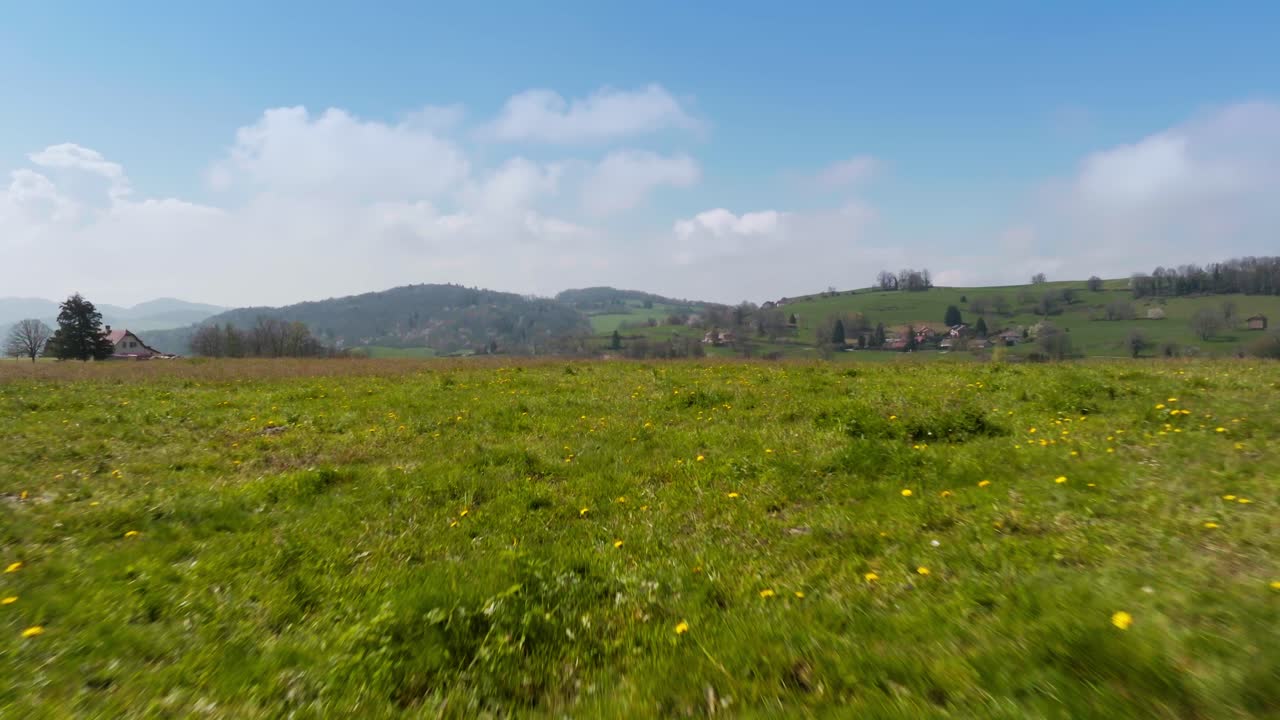 Drone shot with blue sky landscape and green and agricultural meadows on the foothills of the Chartreuse massif, Is&egrave;re, Velanne in Auvergne-Rh&ocirc;ne-Alpes - France