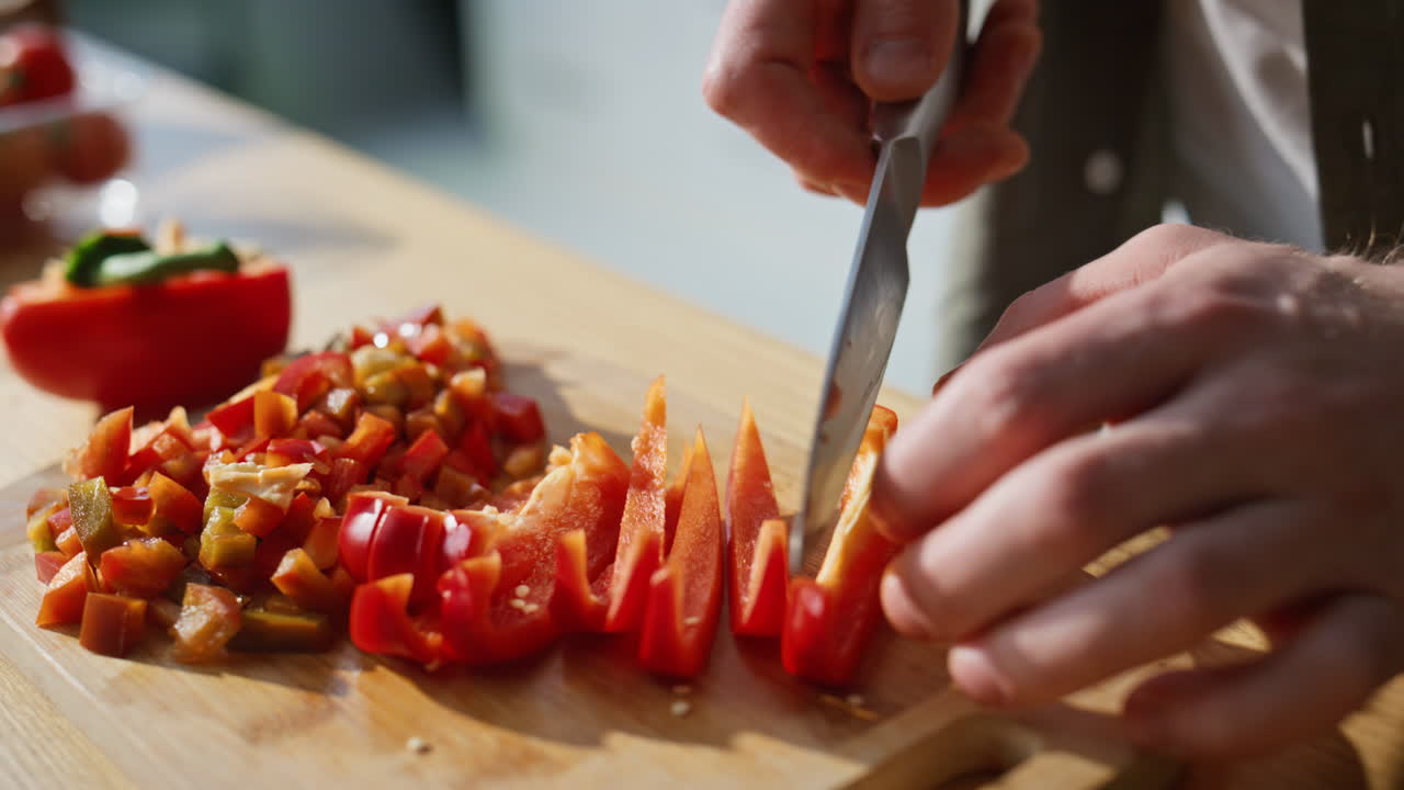 Unknown man slicing vegetables on chopping board home kitchen closeup. Guy hands