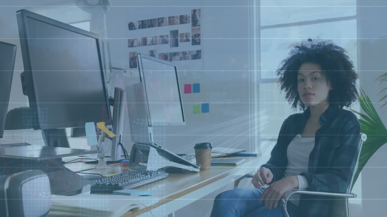 Animation of financial data processing over biracial businesswoman working in office
