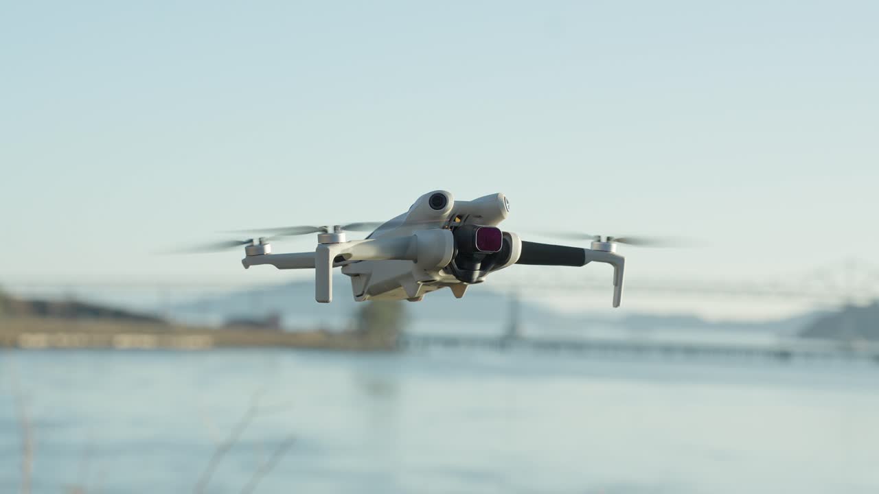 The drone’s compact frame glides above the sand while the Richmond–San Rafael Bridge sits across the Bay on a clear afternoon