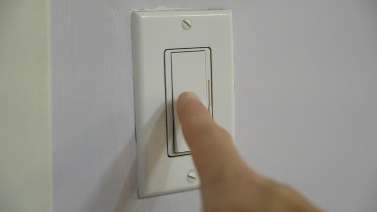 Light switch turning on and off, lamp illumination, indoor lighting, electricity, brightness transition, dark room, glowing bulb, power activation, cinematic interior footage
