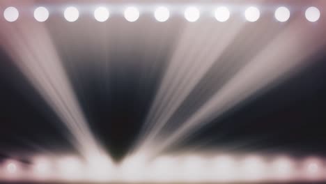 focos brillantes abstractos con haces blancos de luz, fondo monocromático, bucle sin costuras. animación. soffits brillantes sobre fondo negro, concepto de iluminación de escenario
