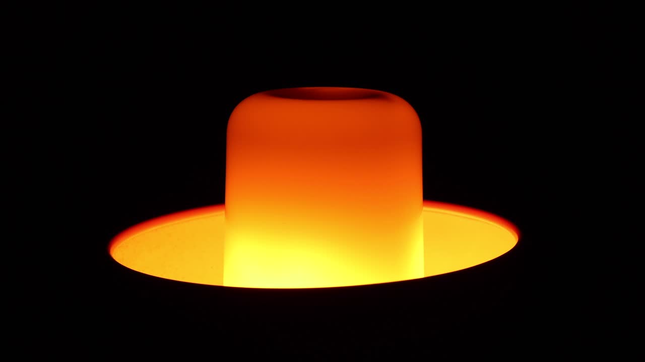 검은 배경에서 빛나는 불 같은 불꽃 전구 닫습니다