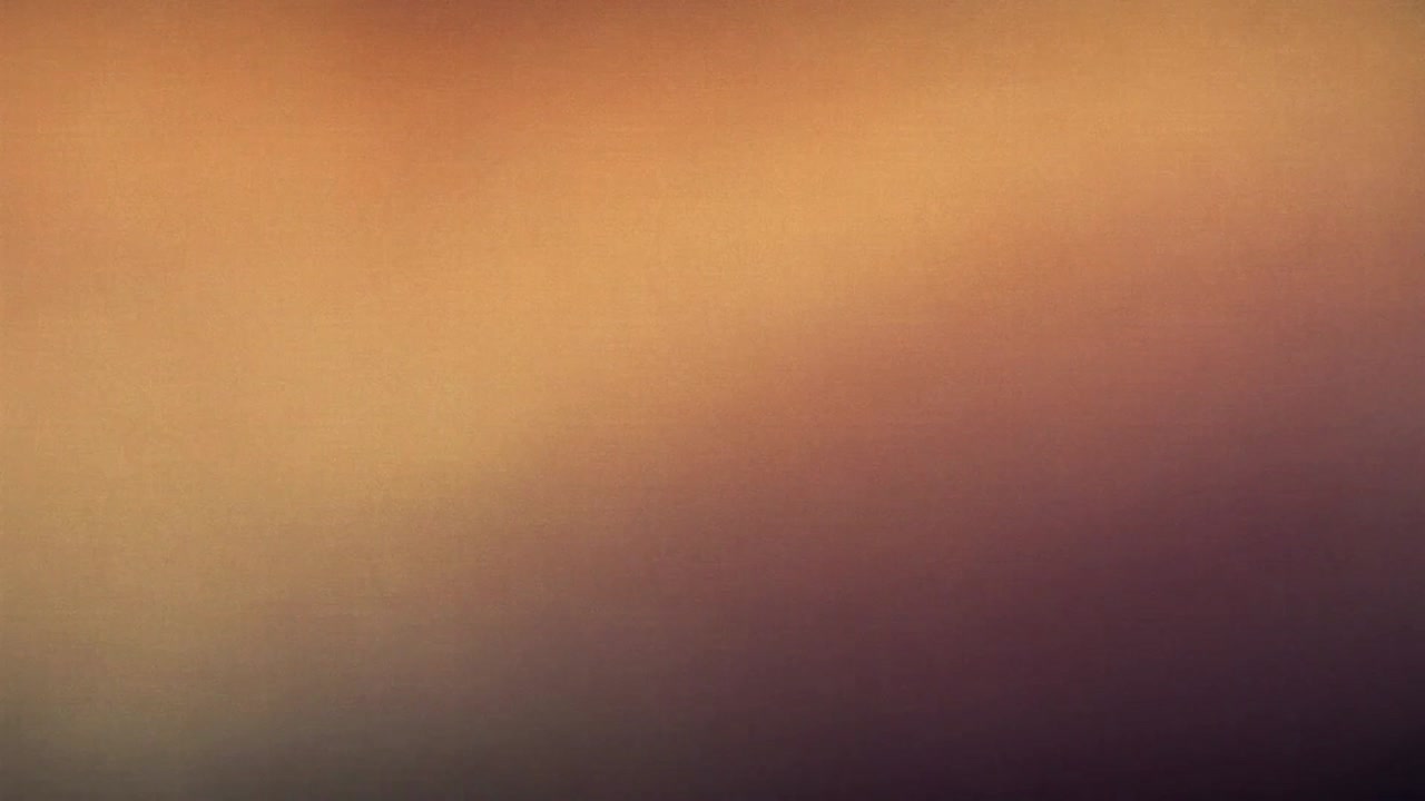 Shifting blurred warm gradient drifting in extreme closeup, triggered by slight camera movement